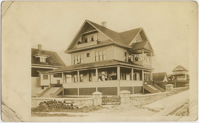 Harry and Mary Foote's house at 2812 Alberta Street, with people on its porch and balconies