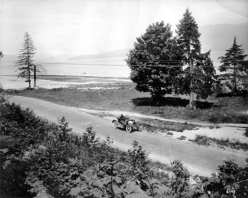 Mr. Greig driving along Marine Drive above Spanish Banks, near Blanca Street