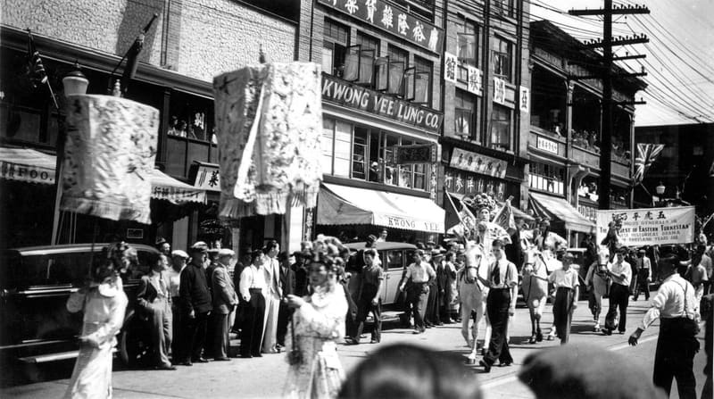 Riders in costume in a Chinese parade on East Pender Street, past the Kwong Yee Lung Co.