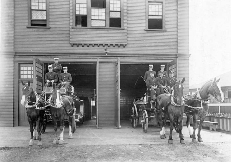 Firemen and their horse-drawn wagons at Fire Hall No. 10, Heather Street and 13th Avenue