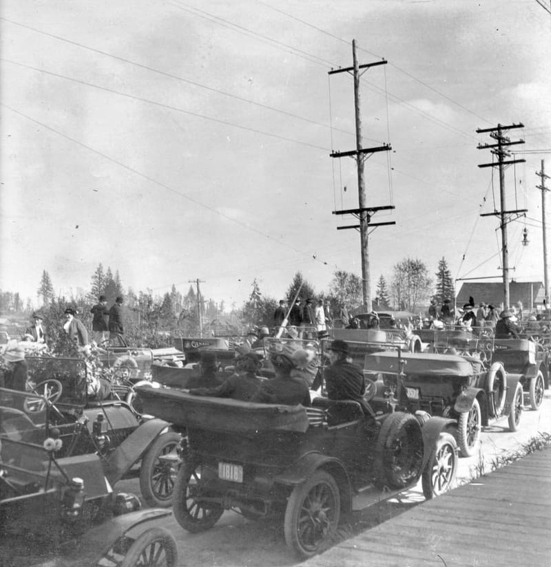 People in open cars gathered for a car rally on Kingsway