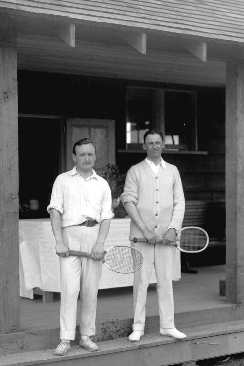 Two men with tennis racquets on the step of the B.C. Electric Lawn Tennis Club at 41st Avenue and Laurel Street