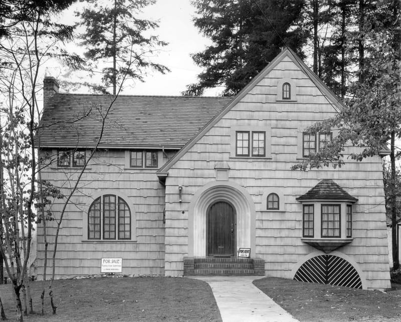 A shingled house with a For Sale sign at 6385 Marguerite Street
