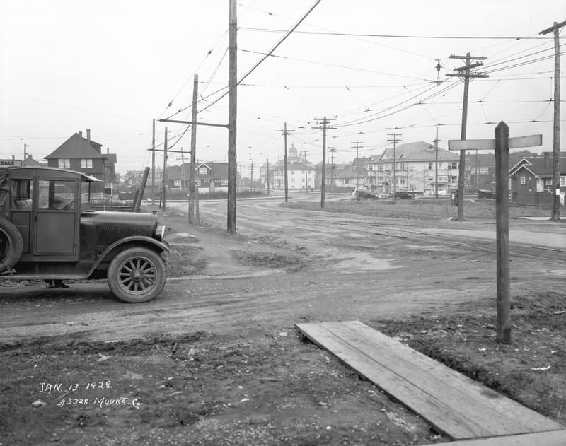 A truck on muddy Oak Street, looking north from 16th Avenue